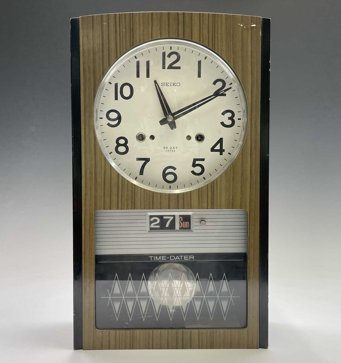 A Seiko Time-Dater thirty-day wall clock, 1960s, with digital day/date and woodgrain finish height