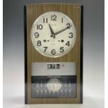 A Seiko Time-Dater thirty-day wall clock, 1960s, with digital day/date and woodgrain finish height