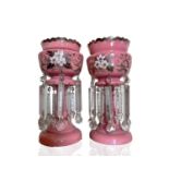 A pair of Victorian pink opaque glass lustre vases, with floral painted and gilt decoration and
