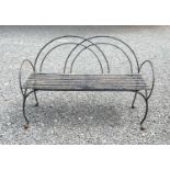 A wrought and cast metal garden bench with arched back and arms. Height 91cm, width 136cm, depth