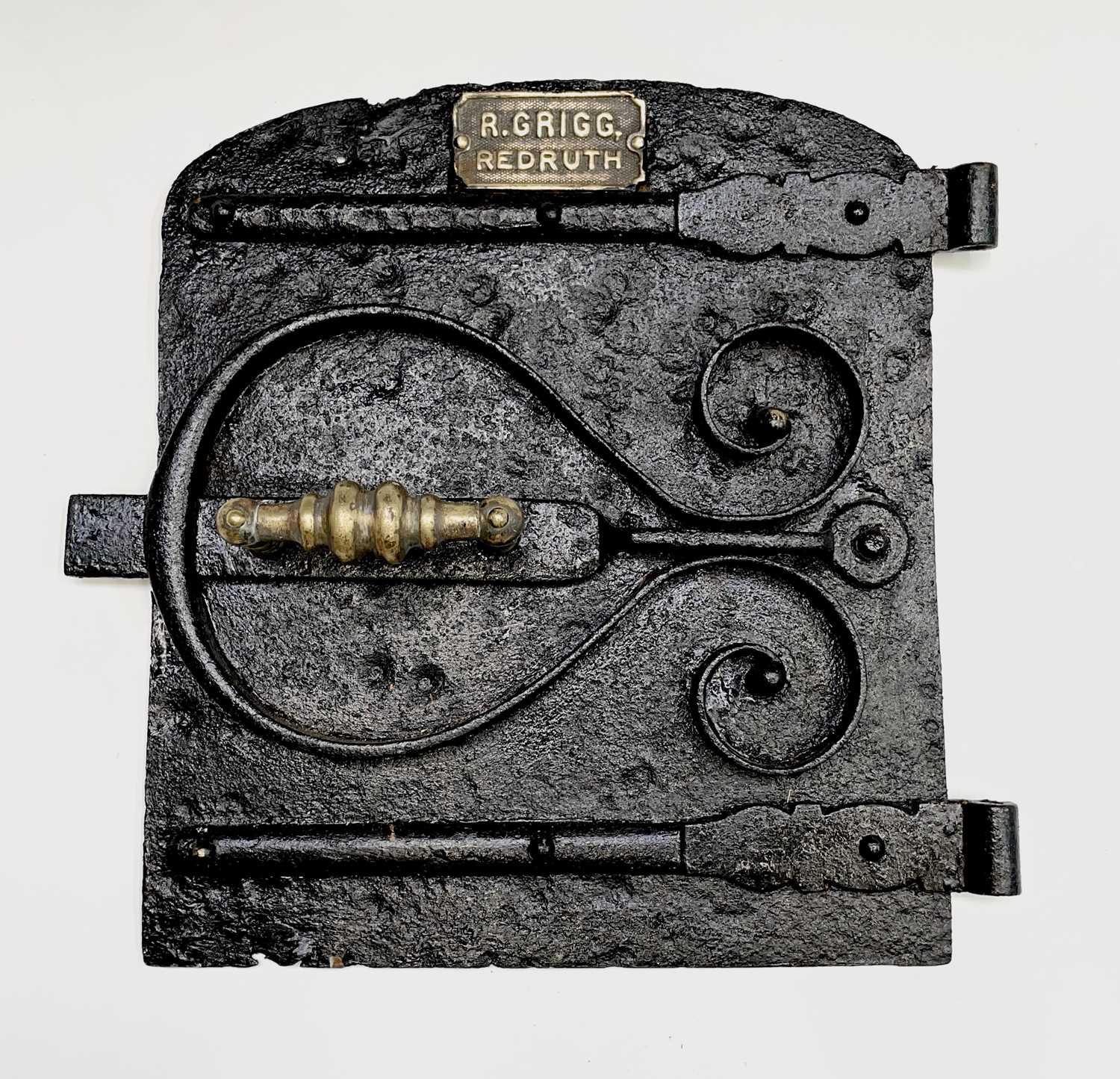 A heavy cast iron Cornish range door, late 19th century, the brass plaque bearing inscription 'R.