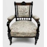 A Victorian ebonised aesthetic period armchair, the back with amboyna panels, with turned, gilt