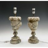 A pair of carved alabaster table lamps, probably circa 1920, with leaf and rose carved relief