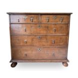 A George II walnut chest of two short and three long drawers, with replacement pear drop handles and
