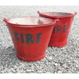 Two red painted 'FIRE' buckets. The tallest 30cm (excluding handle).