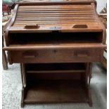 An oak roll top desk, height 102cm, width 76cm, width 49cm.