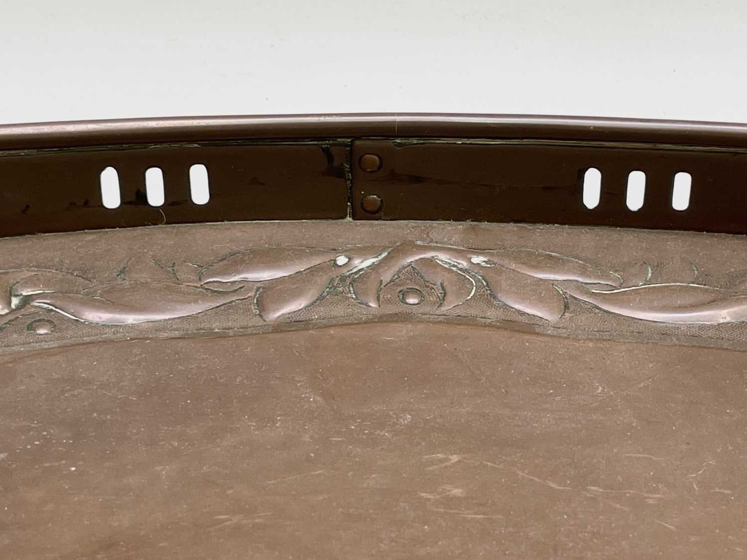 A Newlyn copper oval tray, circa 1910, the raised edge with twin handles, the border repousse - Image 8 of 8