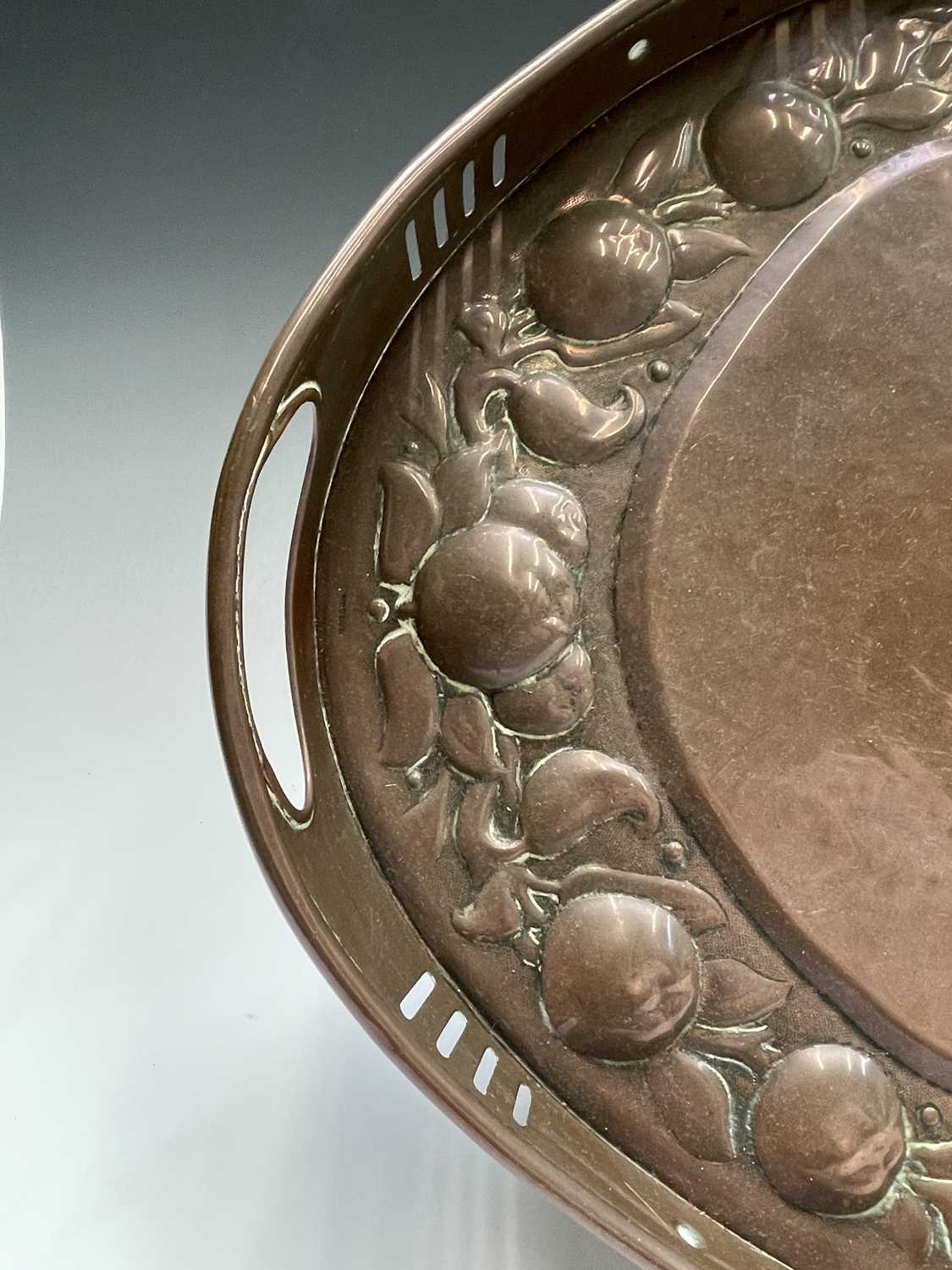 A Newlyn copper oval tray, circa 1910, the raised edge with twin handles, the border repousse - Image 5 of 8