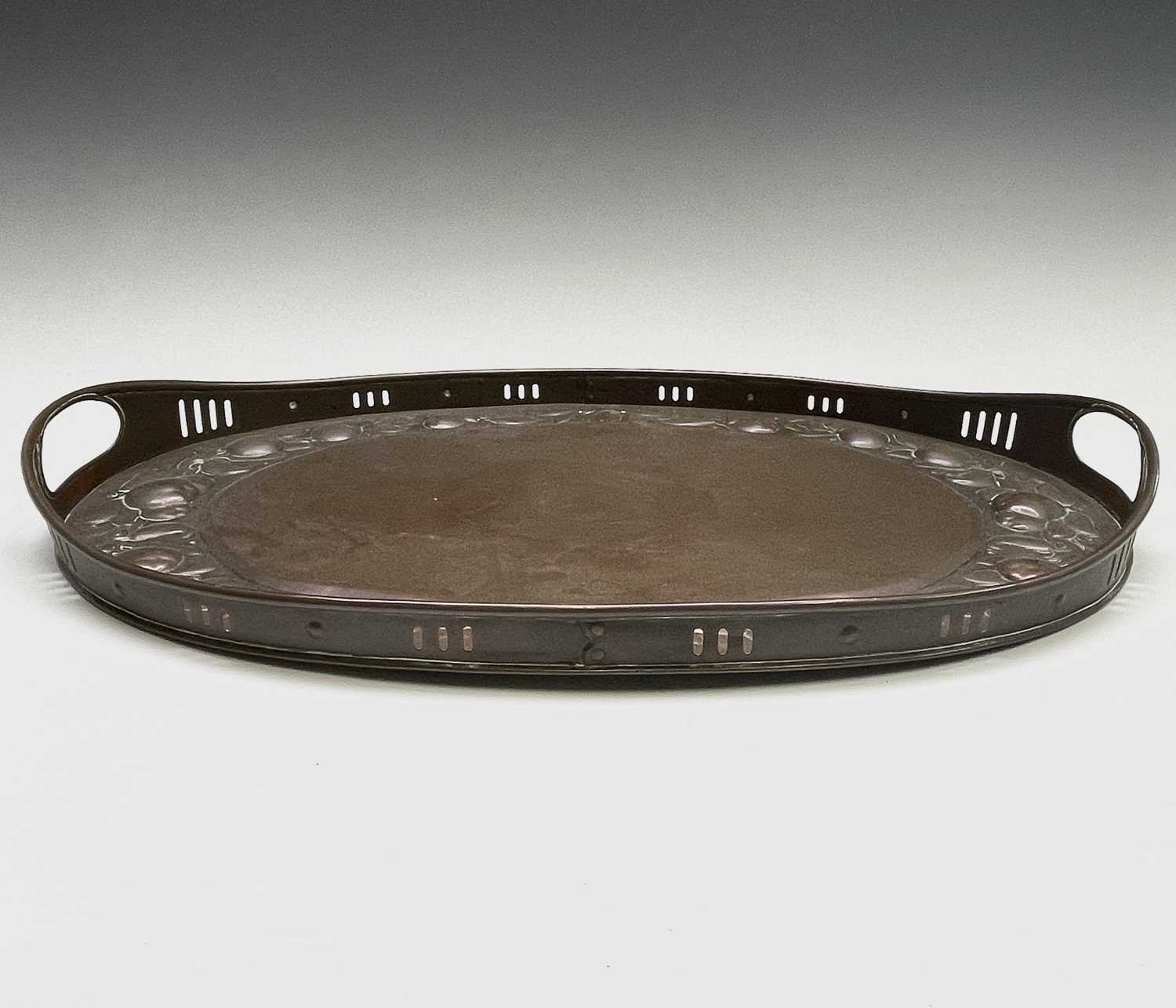 A Newlyn copper oval tray, circa 1910, the raised edge with twin handles, the border repousse - Image 2 of 8