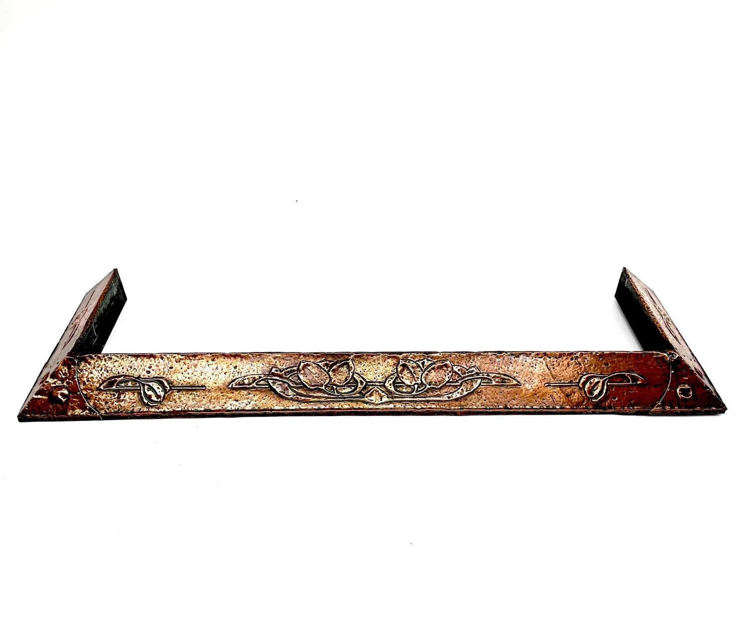 An Arts and Crafts copper fender, embossed with stylised foliage, width 142cm.Condition report: No