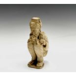 A 19th century Dieppe ivory figure of a bearded man wearing a turban squatting, inscribed and