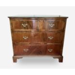 An 18th century walnut and crossbanded chest of two short and two long drawers on bracket feet,