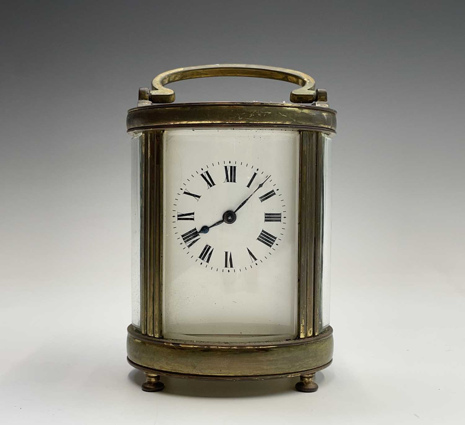 A French oval brass cased carriage timepiece, early 20th century. Height 12.5cm.