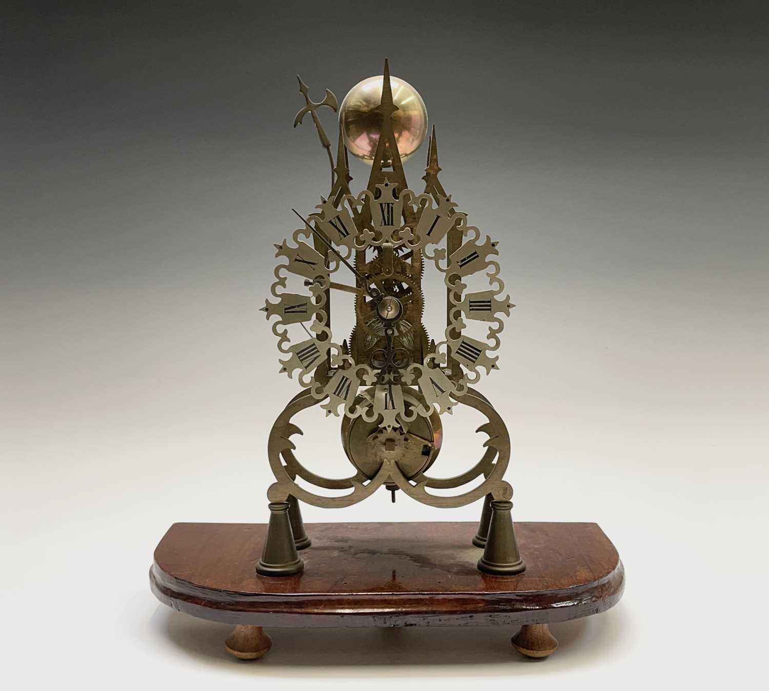 A brass cathedral skeleton clock, 20th century, with single fusee movement, striking on a bell,