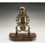 A brass cathedral skeleton clock, 20th century, with single fusee movement, striking on a bell,