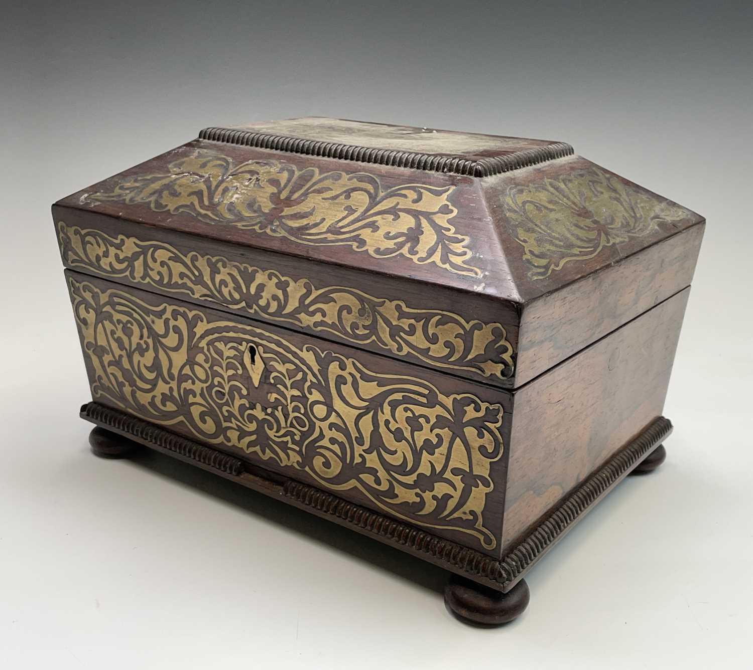 A Regency rosewood and cut brass inlaid box or casket, raised on bun feet, width 30cm. Provenance:
