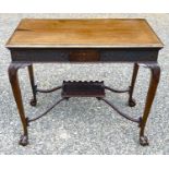 An Edwardian mahogany centre table, with blind fret carved frieze, on cabriole legs with an