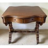 A French walnut serpentine shaped sofa table, circa 1880, fitted with two drawers and raised on