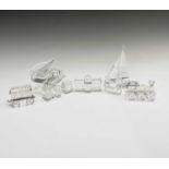 A collection of boxed Swarovski Crystal sculptures to include a grand piano, sailing boat, railway