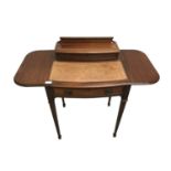 An Edwardian mahogany lady's writing desk, the higned top opening to reveal a fitted interior, brown
