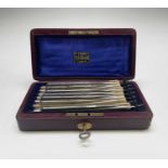 A cased set of seven cut throat razors, each engraved with the days of the week, the red leather