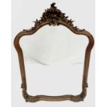 A late 19th century French walnut and parcel gilt wall mirror, with floral carved cresting and base,