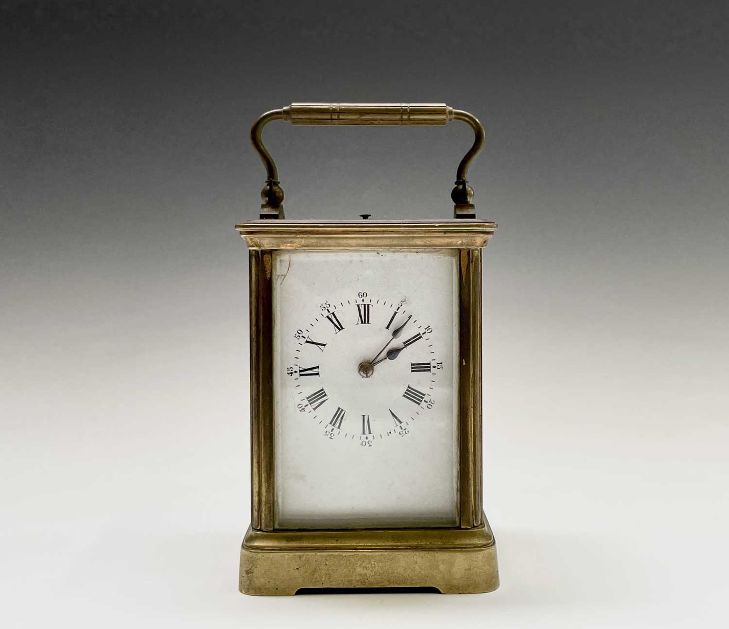 A French brass repeating carriage clock, circa 1900, with white enamel dial, striking on a coiled