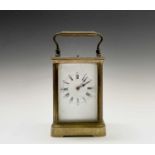 A French brass repeating carriage clock, circa 1900, with white enamel dial, striking on a coiled
