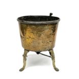 A large brass cauldron or log bin, 19th century, raised upon four cast brass feet, height 75cm,