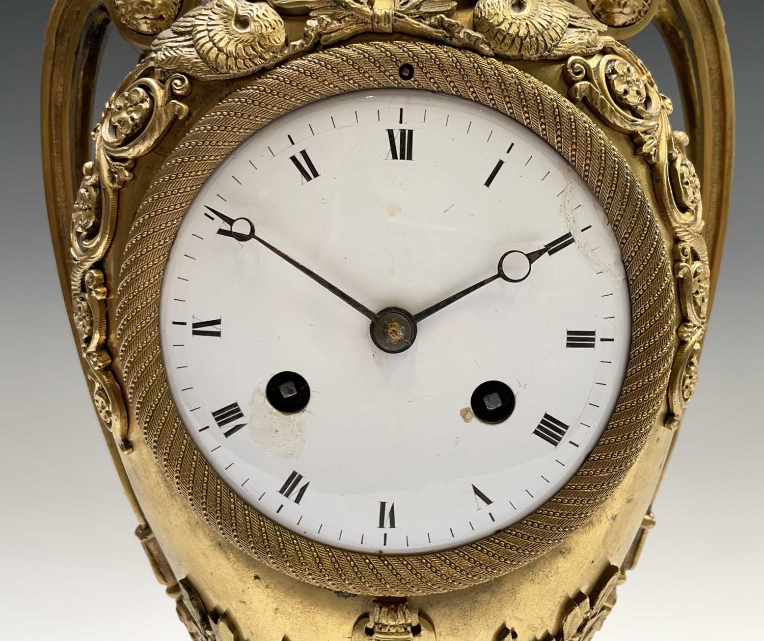 A French Empire ormolu cased mantel clock, of urn form, the covered rim applied with two winged - Image 2 of 12