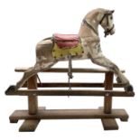 A pine and painted rocking horse, circa 1930, height 85cm, width 92cm, depth 34cm.