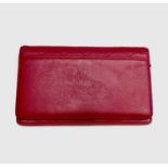 Chanel. Cerise pink lambskin leather wallet, embossed bow design to reverse, grey silver hardware,
