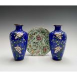 A pair of Japanese cloisonne enamel vases, 20th century, decorated with flowering prunus on a blue