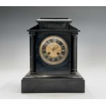 A 19th century black slate mantel clock of architectural form, with relief moulded spelter tablet