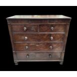 A Victorian mahogany chest of drawers, with a dummy central small frieze drawer above two short