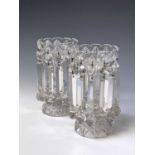 A pair of cut glass lustre vases, circa 1900, the triangular section drops with faceted terminals,