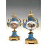 A pair of French 'Sevres' porcelain ormolu mounted cassolettes, late 19th century, with horned