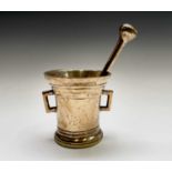 An 18th century bronze pestle and mortar with twin lug handles. Height of the mortar 14cm,