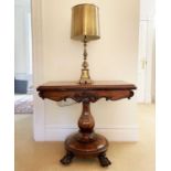 A William IV rosewood fold top tea table, raised on an octagonal baluster pillar and carved circular