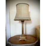 A gilt plaster Corinthian column table lamp with gold brocade shade, overall height 78cm.