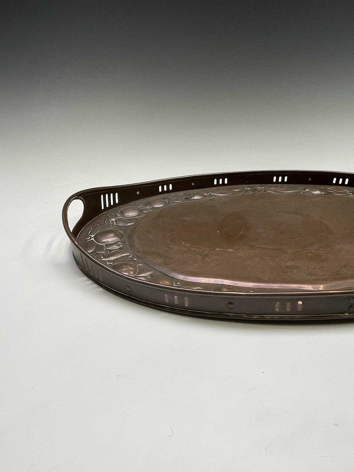 A Newlyn copper oval tray, circa 1910, the raised edge with twin handles, the border repousse - Image 3 of 8