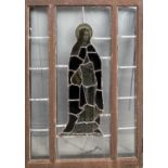 A 19th century stained glass panel depicting a female figure holding a scroll 'Vexilla regis', set