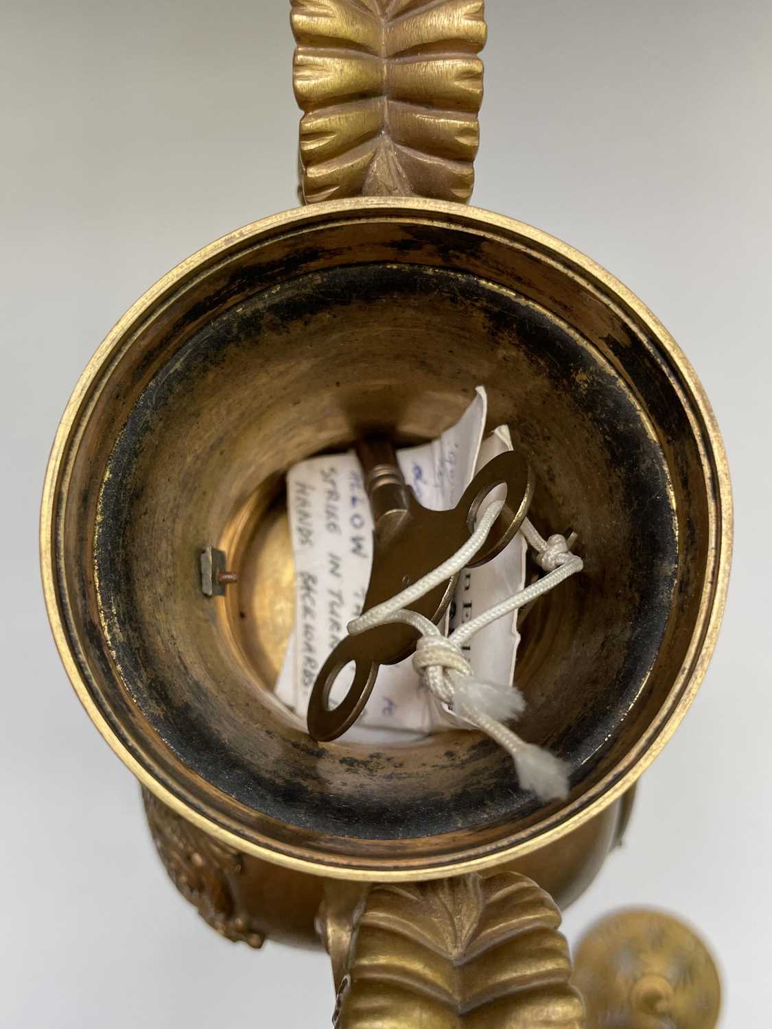 A French Empire ormolu cased mantel clock, of urn form, the covered rim applied with two winged - Image 6 of 12