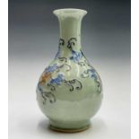 A Chinese celadon porcelain vase, 19th century, with raised painted decoration of vines, fruit and