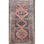 A Hamadan rug, North West Persia, an indigo field with a triple linked medallion, within a pale