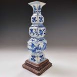 A Chinese blue and porcelain vase, 18th century, the numerous sections decorated with precious