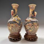 A pair of Japanese Satsuma porcelain vases, 19th century, each secured to the wooden bases, total