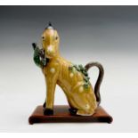 A Chinese sancai-glazed teapot in the form of a horse, possibly Kangxi, with a hardwood stand,