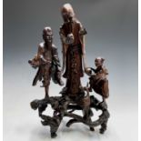 A Chinese root carving of three figures and a bird, 19th century, height 66cm, width 40cm.