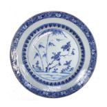 A Chinese blue and white porcelain charger, Kangxi period, with a flowering tree, bamboo and